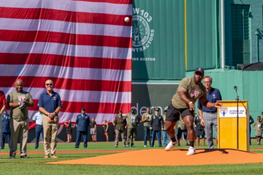 Group photo of veterans on a baseball field.